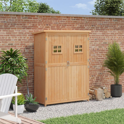 Natural wooden garden shed standing against a brick garden wall