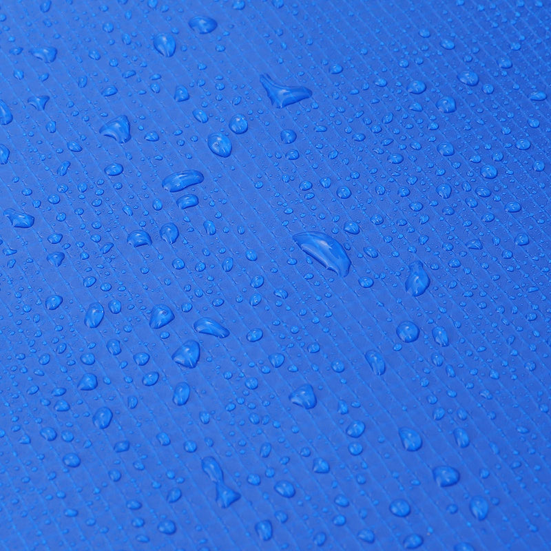 Close-up of the safety pad's water-resistant blue fabric with water droplets beaded on the surface
