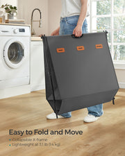 Songmics laundry hamper folded flat and being carried