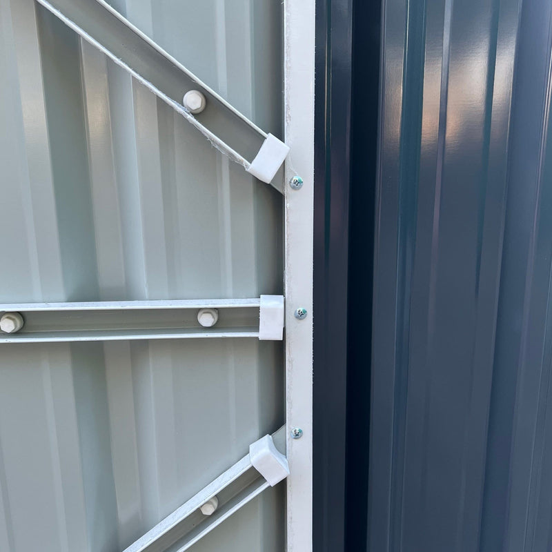 Close-up of the diagonal steel brace bracket fixed inside the shed door frame