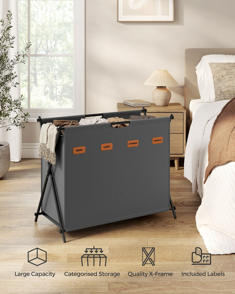 Songmics laundry hamper styled in a bedroom next to a bed