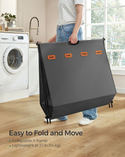 Songmics laundry hamper folded flat and being carried