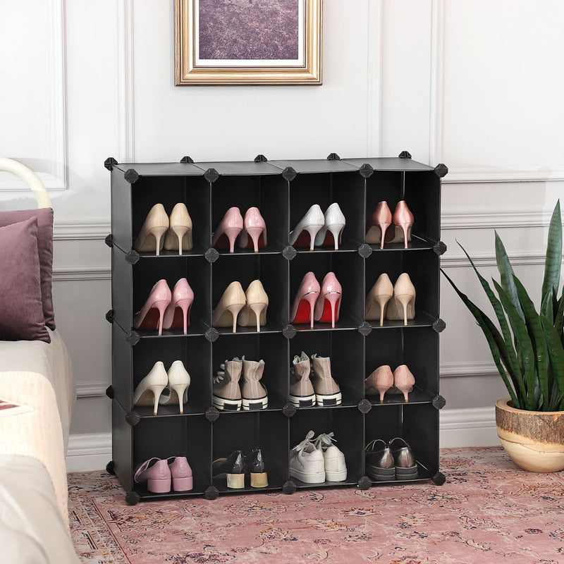 Black cube shoe organiser in a bedroom holding rows of heels and trainers