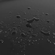 Close-up of water droplets on the smooth black panel surface showing its wipe-clean finish