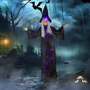 Hanging witch decoration displayed outdoors in a dark, stormy Halloween scene