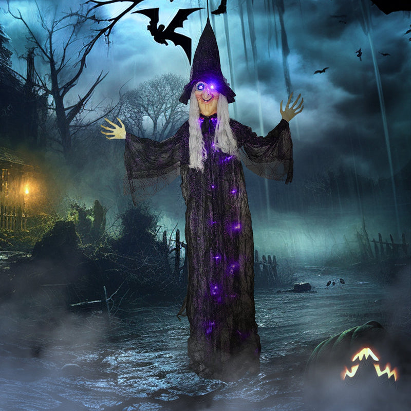 Hanging witch decoration displayed outdoors in a dark, stormy Halloween scene