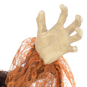 Close-up of the witch's clawed hand holding tattered fabric