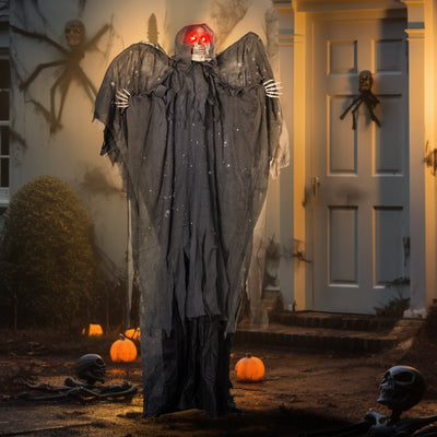 Winged grim reaper animatronic on a porch at night with pumpkins
