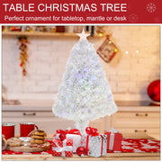 White tabletop Christmas tree on a kitchen counter surrounded by gifts