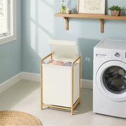 The bamboo laundry sorter beside a washing machine in a blue laundry room