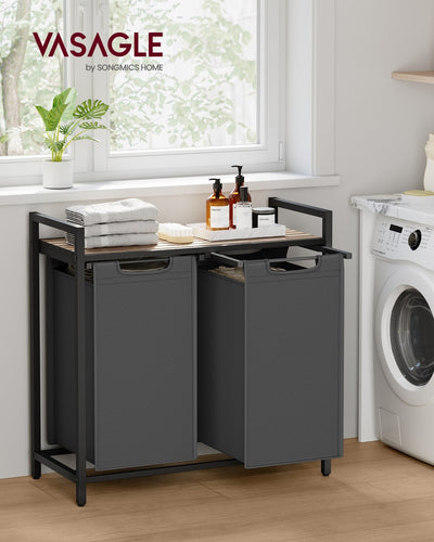 Vasagle laundry sorter in a bright laundry room with folded towels on the shelf beside a washing machine