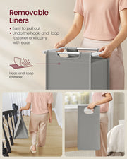 Person lifting a removable laundry bag out of the frame and carrying it upstairs
