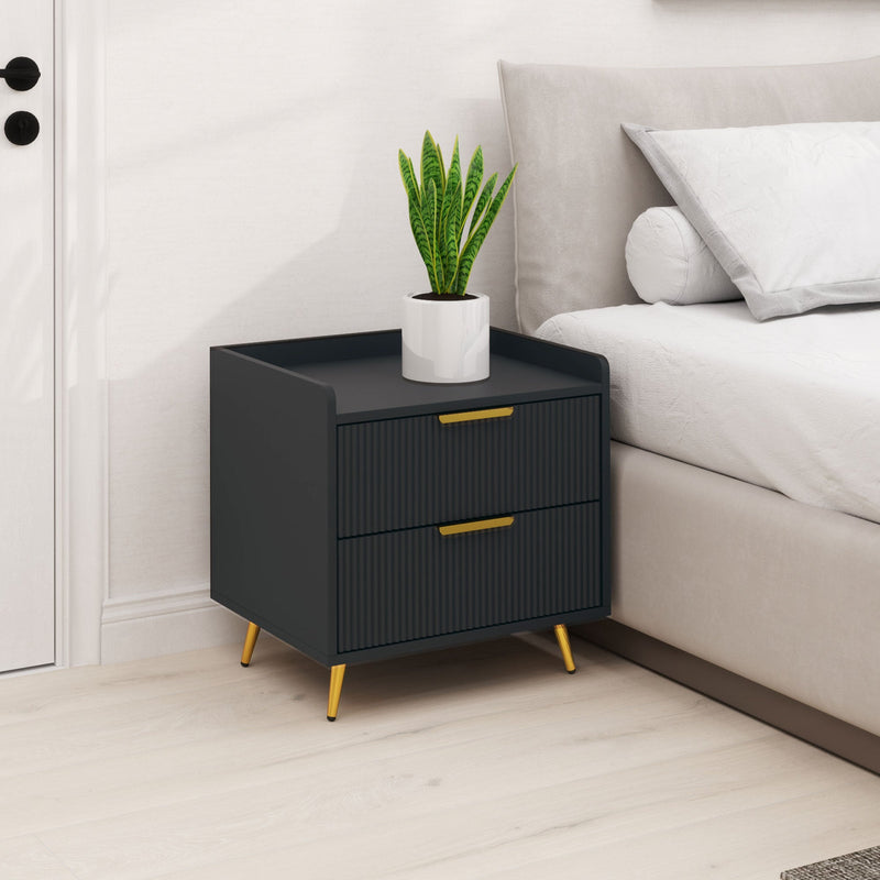 Bedside table next to a made bed with a potted plant on the raised-edge top