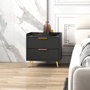 Bedside table in a bedroom with a marble feature wall and a tray on top