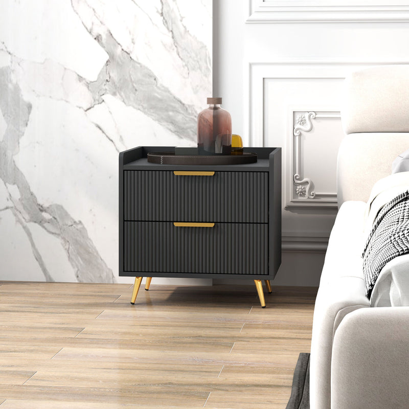 Bedside table in a bedroom with a marble feature wall and a tray on top