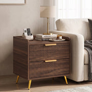 Bedside table used beside a cream sofa with a table lamp, remote and books
