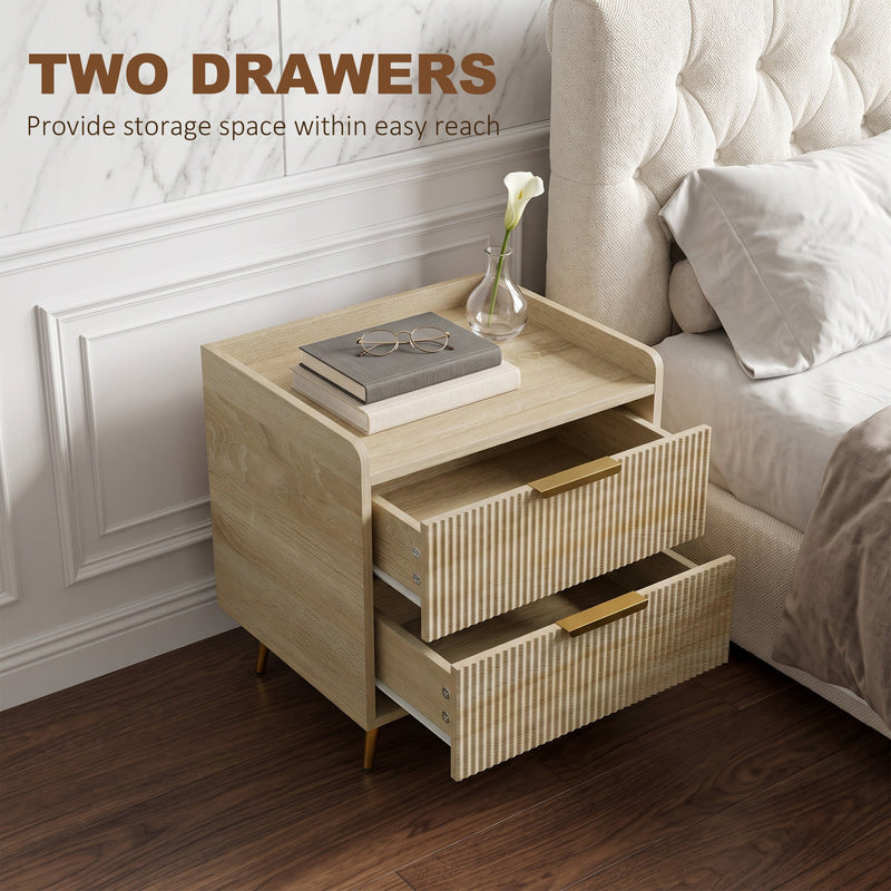 Open drawers revealing storage next to an upholstered bed and a lily in a vase