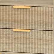 Macro view of the fluted wood-effect drawer fronts and gold handles
