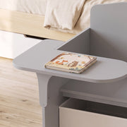Close-up of the tabletop and storage drawer used as a bedside unit