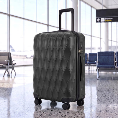 Black suitcase standing in an airport departure lounge