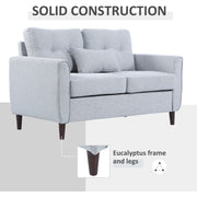 Grey sofa styled in a living room with picture frame and plant