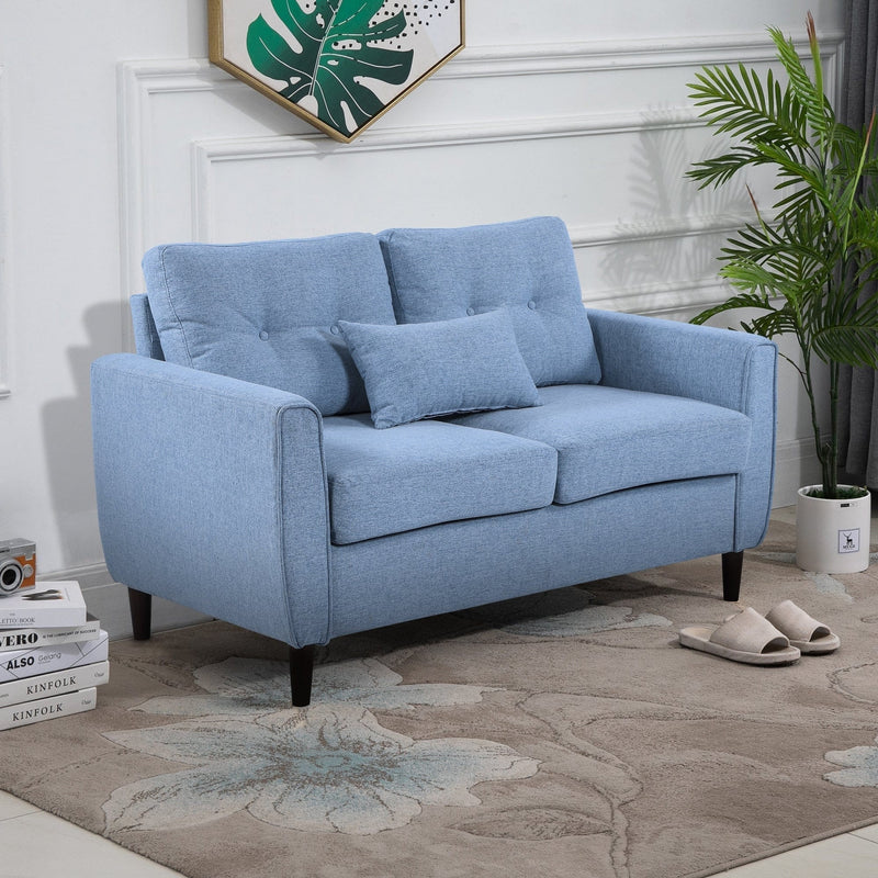 Blue tufted 2 seater fabric loveseat sofa in a modern living room