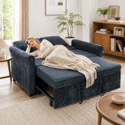 Woman napping under a throw on the dark blue sofa bed extended flat as a guest bed