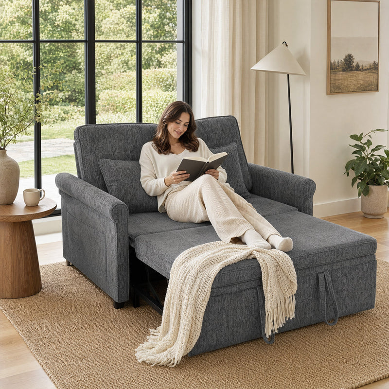 Woman reading a book on the pulled-out seat beside a large window with a throw draped across