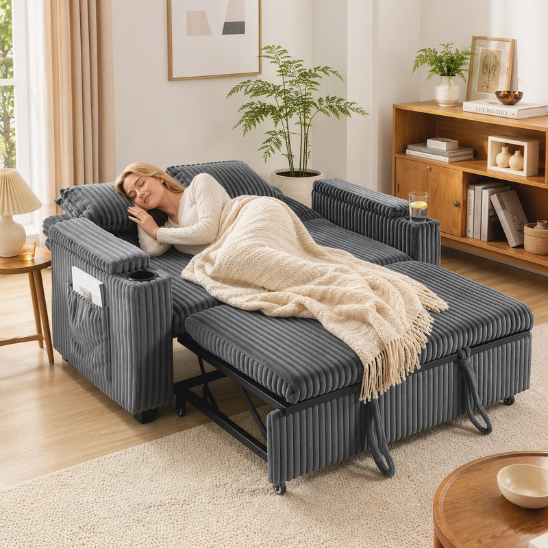 Woman sleeping on the dark grey sofa bed pulled out into bed mode with a throw blanket