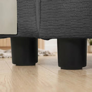 Close-up of the round black plastic legs under the sofa base