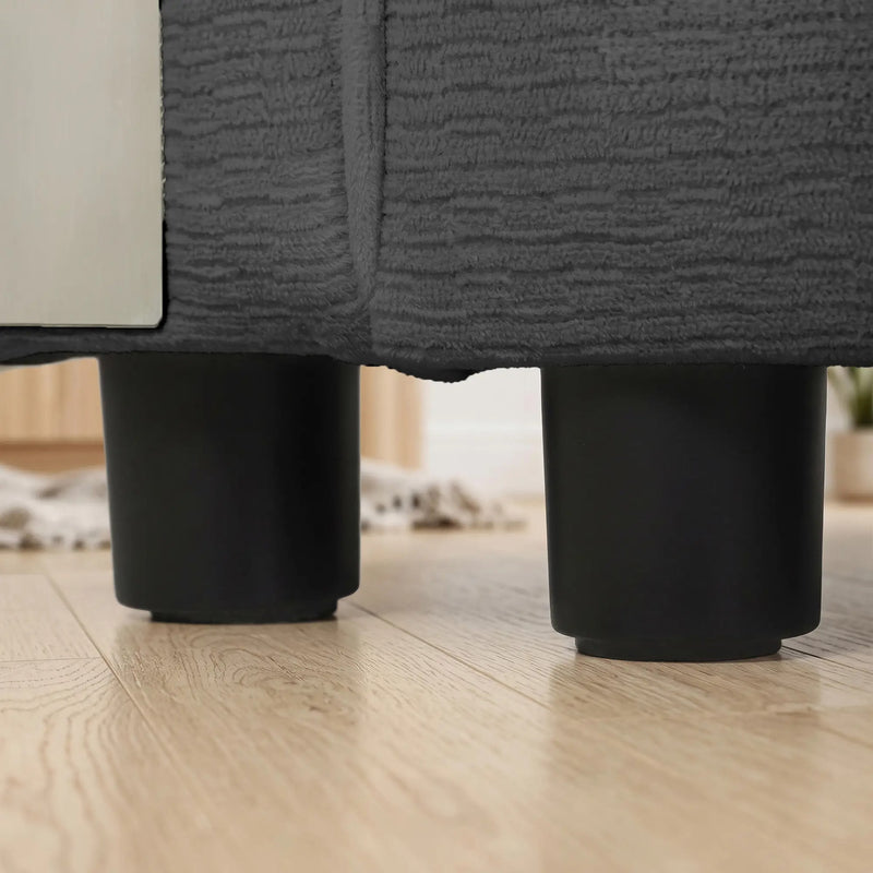Close-up of the round black plastic legs under the sofa base