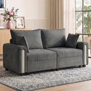 Velvet loveseat on a patterned rug in front of a sideboard with flowers