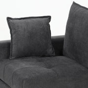 Close-up of a scatter cushion resting on the tufted seat and backrest