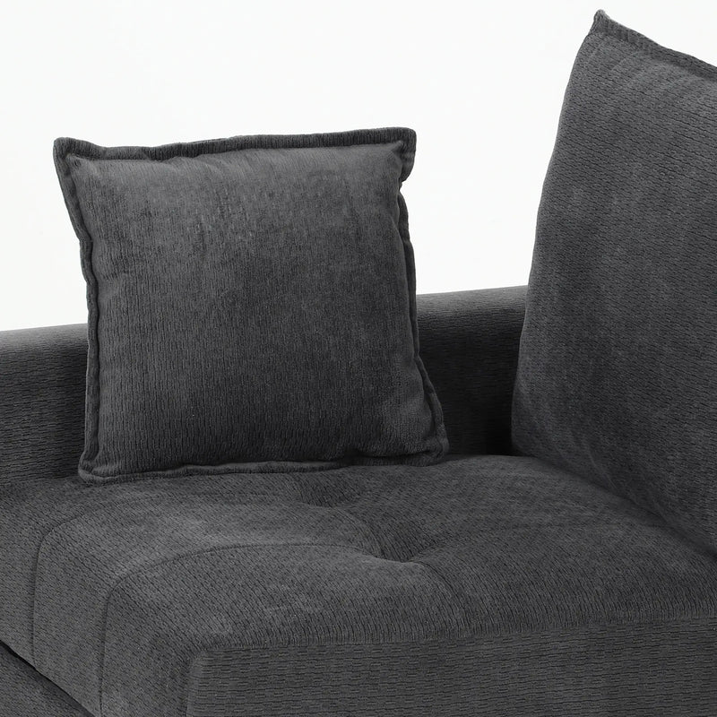Close-up of a scatter cushion resting on the tufted seat and backrest