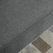 Close-up of the grey linen-look sofa fabric and seam