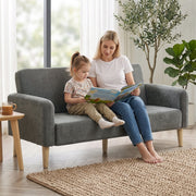 Mother and child sitting together on the grey velvet 2 seater sofa