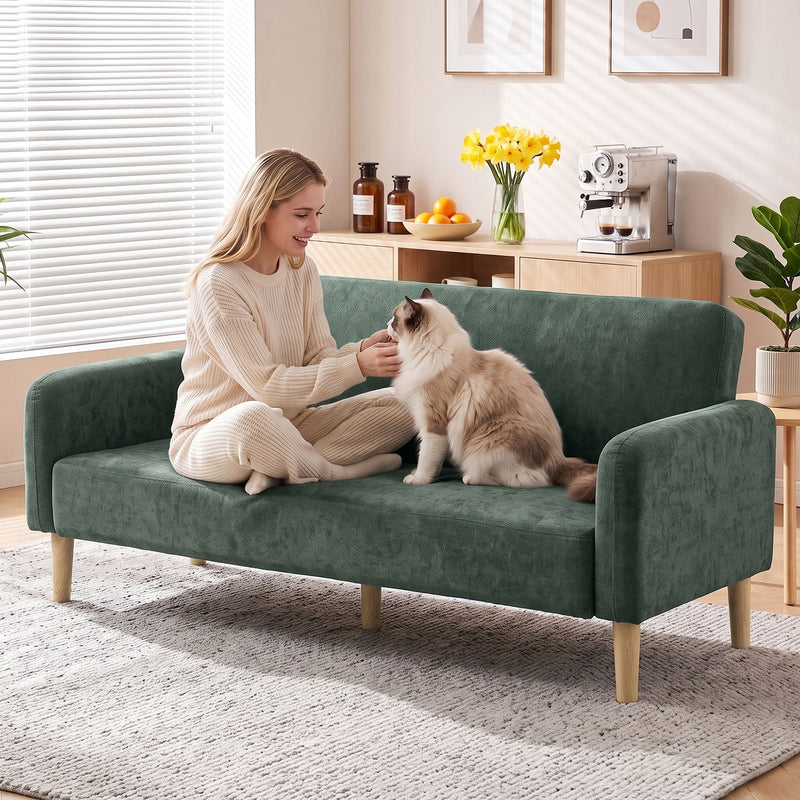 Woman relaxing on the sofa with a cat in a bright living room