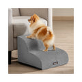 Pomeranian climbing Feandrea 2-step dog stairs in Dove Grey beside an armchair