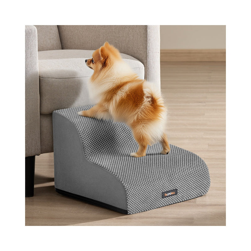 Pomeranian climbing Feandrea 2-step dog stairs in Dove Grey beside an armchair