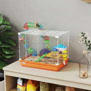 Orange and white hamster cage shown on a sideboard beside potted plants