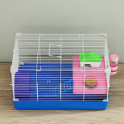 Blue and white hamster cage shown on a wooden floor with bedding inside