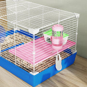Overhead angle of the pink platform, water bottle and wheel inside the cage
