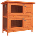 2-tier rabbit hutch in vintage yellow varnished wood with two wire-mesh doors and two solid doors