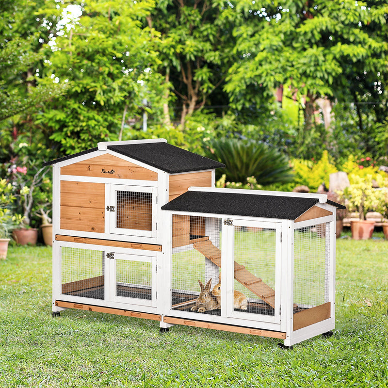 Rabbit hutch set up outdoors in a garden with rabbits inside the run