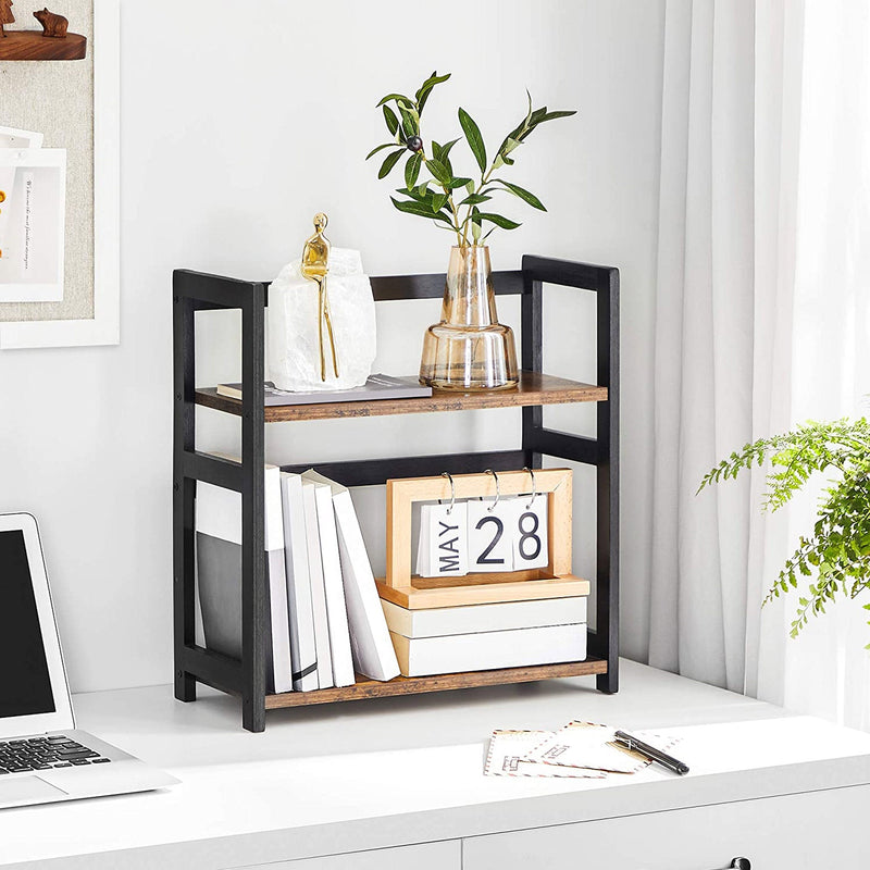 Spice rack on a desk holding a vase, books and a paper calendar