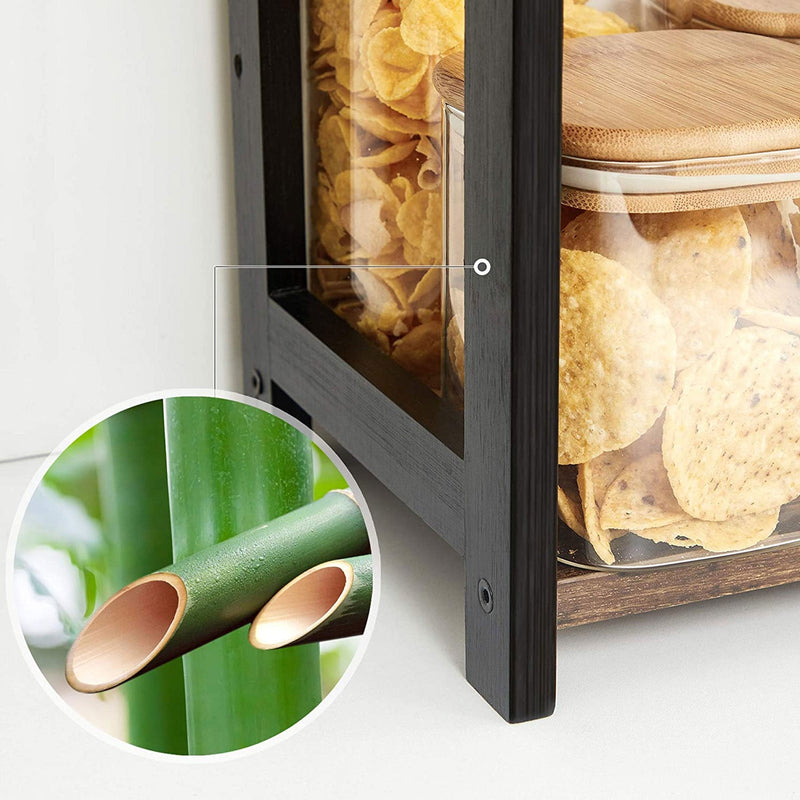 Close-up of the black bamboo upright beside glass jars, with a bamboo inset