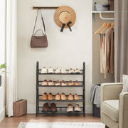 Two 2 tier shoe racks stacked into a 4 tier unit beside hanging clothes
