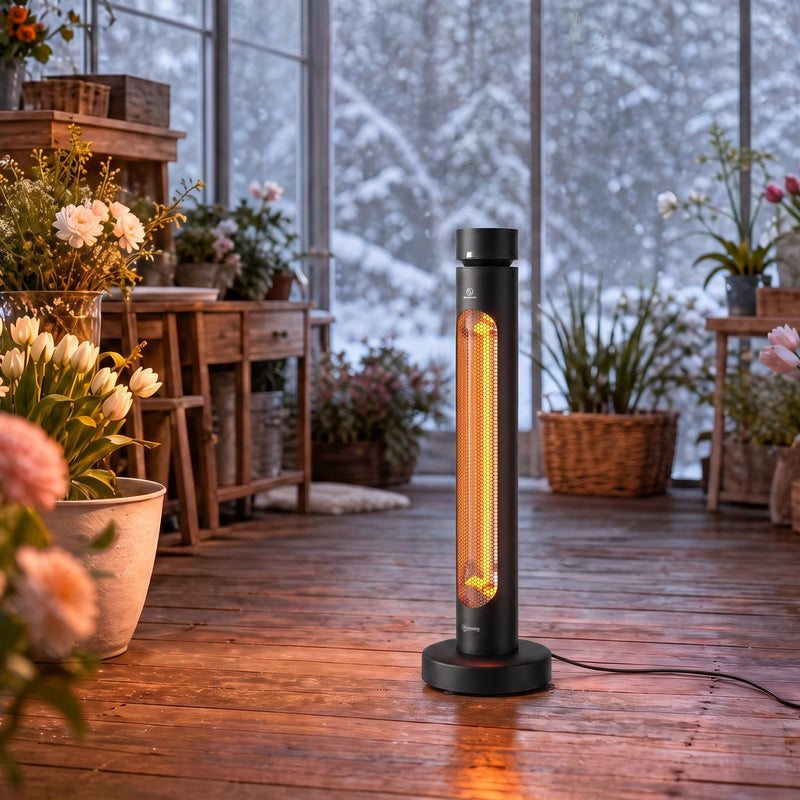 Black patio heater standing in a snowy conservatory among flowers