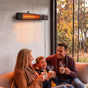 Black wall-mounted patio heater above a family sitting on an outdoor sofa