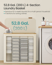 The 200 L laundry basket open to show 4 sections of folded washing beside a washing machine